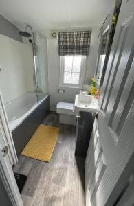 a bathroom with a tub and a sink and a toilet at The Dean's on the Lune in Heysham +16 photos