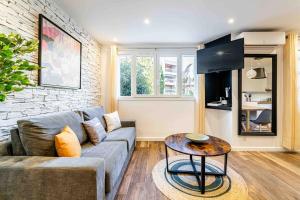 a living room with a couch and a table at Cassis Le Marignan in Cassis