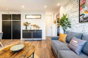 a living room with a couch and a table at Cassis Le Marignan in Cassis