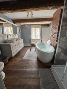 a bathroom with a bath tub and a sink at Millers Kate mit Elbblick in Lauenburg +17 photos