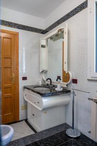 a bathroom with a sink and a mirror at Panoramic Villa Fiore di Limone near Cefalú in Santo Stefano di Camastra