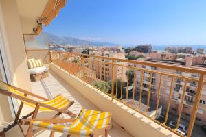 a balcony with chairs and a view of the city at Luxury 2bedrms with SeaView CityCenter&Parking #4 in Roquebrune-Cap-Martin