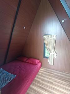 a bed in a room with a window at Wawowow in Tomohon +20 photos