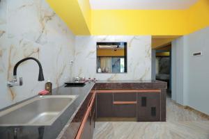 a kitchen with a sink and a counter top at HOTEL CYRIL in Kanyakumari +48 photos