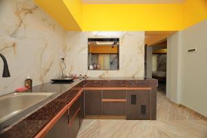a kitchen with a sink and a counter top at HOTEL CYRIL in Kanyakumari +27 photos