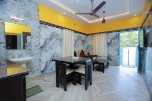 a bathroom with a sink and a desk in a room at HOTEL CYRIL in Kanyakumari