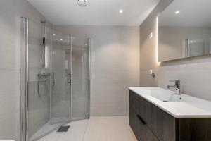 a bathroom with a sink and a shower at Oslo Gateway Apartment in Lørenskog in Lorenskog