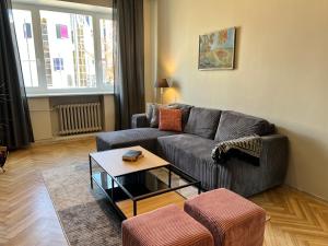a living room with a couch and a coffee table at Reval Residences City Center in Tallinn