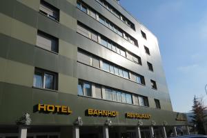 a building with a hotel sign on the side of it at Hotel Bahnhof in Uzwil
