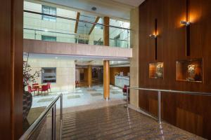 a lobby of a building with a staircase in a building at Crisol Almería in Almería