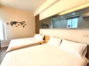 Una cama o camas en una habitación de 日晴民宿 Sun Day