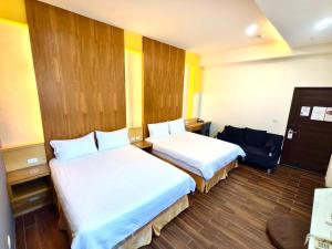 Una cama o camas en una habitación de 日晴民宿 Sun Day
