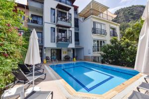 an image of a swimming pool in front of a building at Mykonut Boutique Suites in Fethiye
