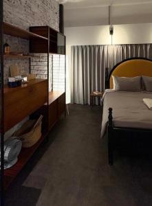 a bedroom with a bed and a brick wall at Light Room in Tainan