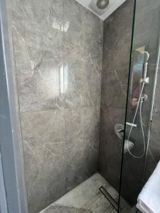 a shower with a glass door in a bathroom at Studio beverly hills premium sheikh Zayed in Sheikh Zayed