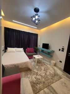 a bedroom with a bed and a couch and a table at Studio beverly hills premium sheikh Zayed in Sheikh Zayed