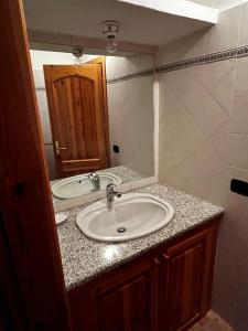 a bathroom with a sink and a mirror at Dimora storica Gallurese vicino al Lago in Sant Antonio Di Gallura