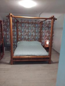 a bed with a wooden frame in a room at Villas Paradis in Saint-Paul-lès-Dax +16 photos