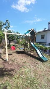 a playground with a slide in a yard at Villa Moiko in La Parra