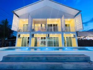 a house with a swimming pool in front of it at High Lamoon in Sathani Khlong Rian