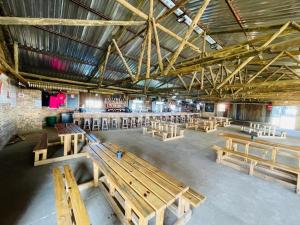 a large room with wooden benches in a building at Stonehouse in Carolina