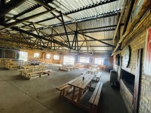 a large room with wooden benches in a building at Stonehouse in Carolina