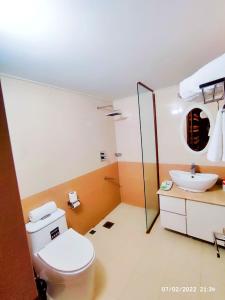 a bathroom with a toilet and a sink at Rass Resort Gazipur in Gazipur