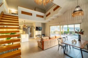 a living room with a couch and a table at Jarko Luxury Houses in Argoulidhés