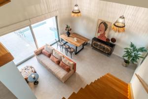 an overhead view of a living room with a couch and a table at Jarko Luxury Houses in Argoulidhés
