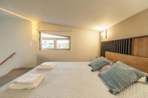 a bedroom with a large bed with two pillows on it at Jarko Luxury Houses in Argoulidhés