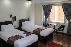 Postel nebo postele na pokoji v ubytování Apartment Hotel 11 Thamel