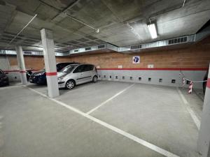 a parking garage with two cars parked in it at "Breeze" Aparthotel by Parrot`s House in Lloret de Mar