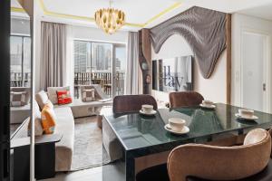 a living room with a table and chairs at Dune Escape Stylish Poolside Courtyard Retreat in Dubai