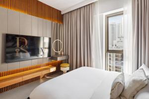 a bedroom with a white bed and a large window at Dune Escape Stylish Poolside Courtyard Retreat in Dubai +28 photos