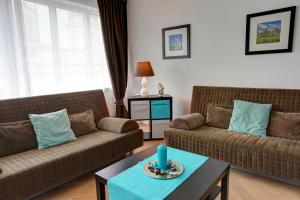 a living room with two couches and a table at Gasser Apartments - Apartments Karlskirche in Vienna