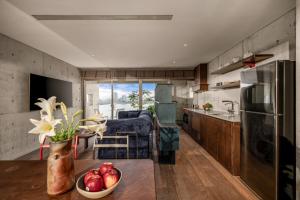 a kitchen with a bowl of fruit on a table at Oday Stay Boutique Hotel Da Nang - 2 Minutes to Dragon Bridge in Danang