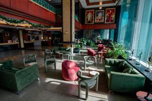 a lobby with couches and chairs and a bar at Town in Town Hotel Bangkok in Bangkok