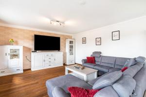 a living room with a couch and a tv at Ferienhaus St Georg Stube in Grömbach