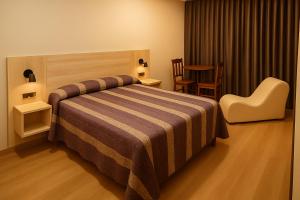 A bed or beds in a room at Motel Latino