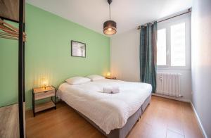 a bedroom with a large bed and a window at Belfort Break in Chalon-sur-Saône