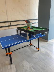 a ping pong table with a ping pong ball on it at Magdalena Cozy Apartment in Sparta
