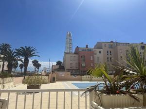 a view of a pool with buildings and palm trees at Appartement une chambre CAP D'AGDE CT950-206 in Cap d'Agde