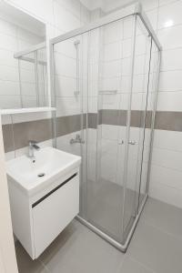 a bathroom with a glass shower and a sink at R HOUSE HOTEL in Bodrum City +45 photos