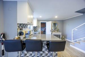 a kitchen with a counter and some blue walls at Casa da Fonte by YOUR KEY - 1st floor house in Ribeira Brava +29 photos