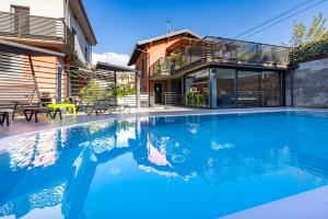 a house with a swimming pool in front of a house at The Lake Home in Colico