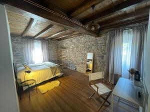 a bedroom with a bed and a table and a chair at Casa APEZTEGUIA in Narvarte