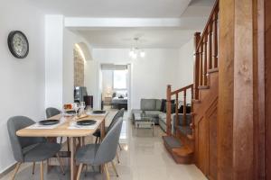 a dining room and living room with a table and chairs at Casa Aurora Rhodes in Rhodes Town