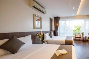 Postel nebo postele na pokoji v ubytování An Phú Villa Sầm Sơn - Venuestay