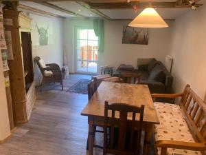 a living room with a table and chairs and a couch at Tarahaus in Sankt Georgen im Schwarzwald