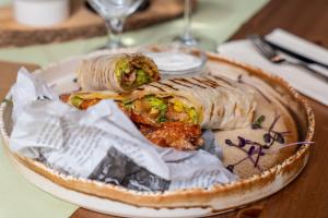 a plate of food with a wrap on a table at Hotel Liptov in Belá